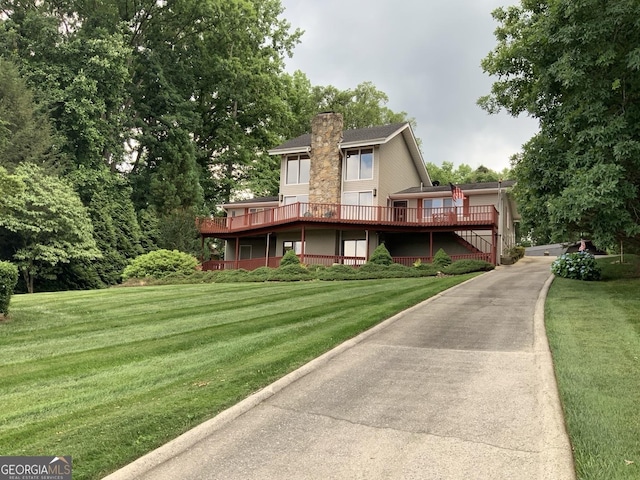 view of front of property with a front yard and a deck