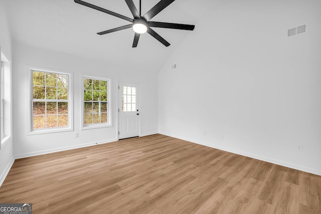 unfurnished room with ceiling fan, high vaulted ceiling, and light hardwood / wood-style flooring