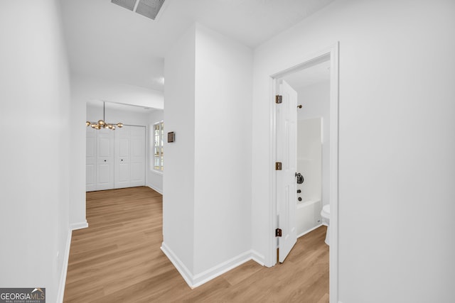 hall with light hardwood / wood-style flooring