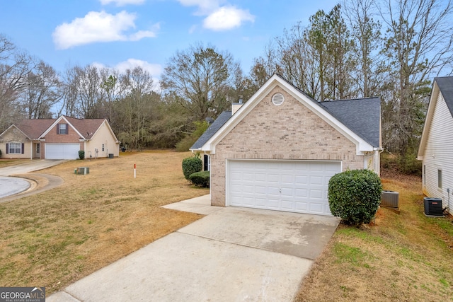 exterior space with a garage, central air condition unit, and a front lawn