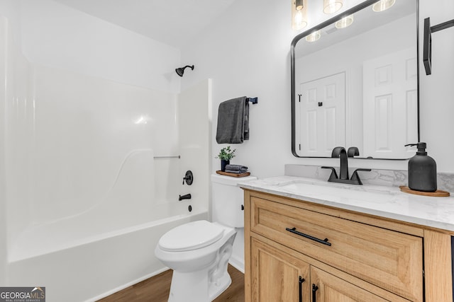 full bathroom with vanity, wood-type flooring,  shower combination, and toilet