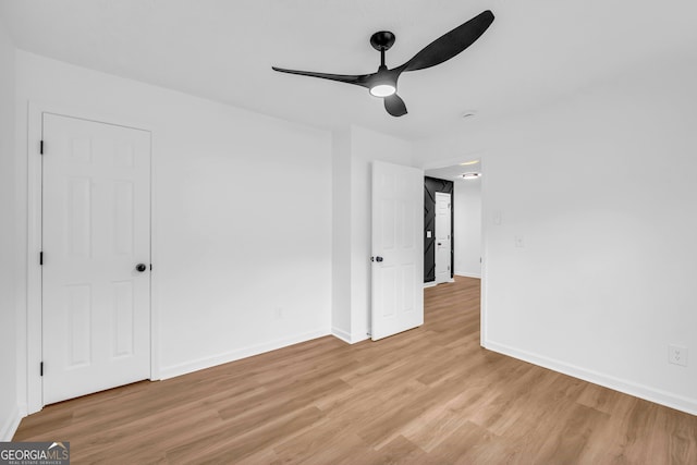 unfurnished room with ceiling fan and light hardwood / wood-style floors