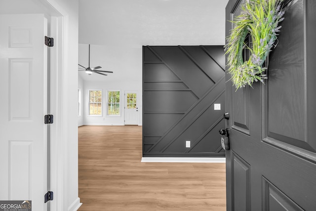 foyer entrance with light hardwood / wood-style floors and ceiling fan