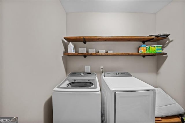 clothes washing area featuring separate washer and dryer