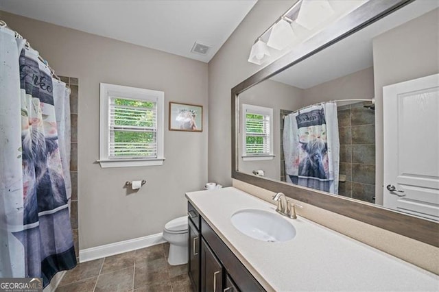 bathroom with vanity, curtained shower, tile patterned floors, and toilet