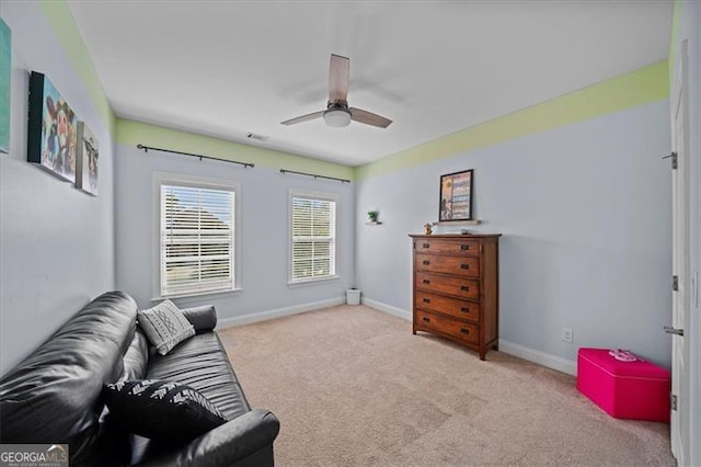 sitting room featuring ceiling fan and light colored carpet