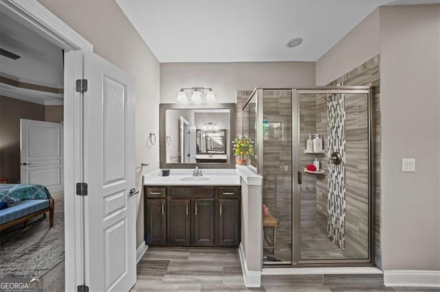 bathroom with walk in shower, vanity, and hardwood / wood-style flooring