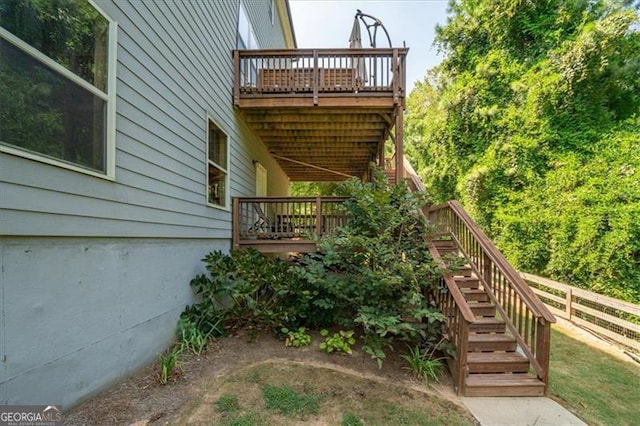 view of side of home featuring a wooden deck