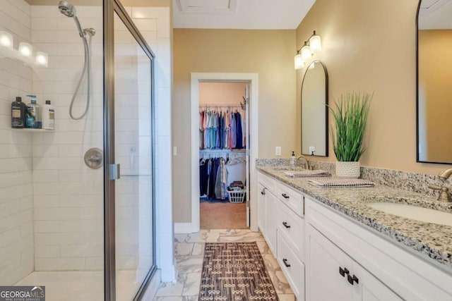 bathroom featuring an enclosed shower and vanity