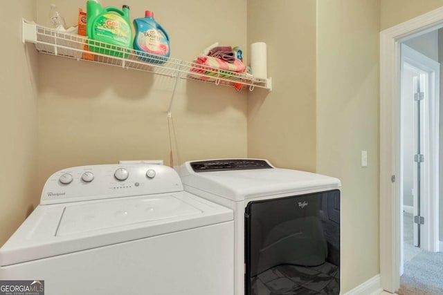 clothes washing area with washer and clothes dryer and carpet flooring