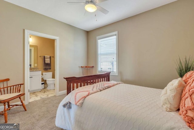 carpeted bedroom featuring connected bathroom and ceiling fan