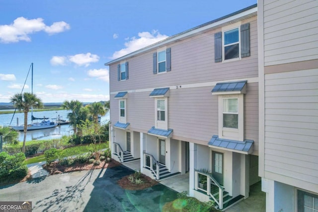 rear view of house featuring a water view