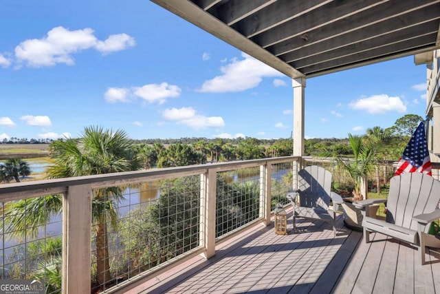 wooden deck featuring a water view