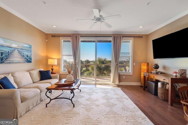 living room with hardwood / wood-style floors, ornamental molding, and ceiling fan