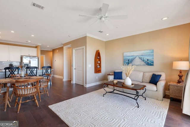 living room with crown molding, ceiling fan, and dark hardwood / wood-style flooring