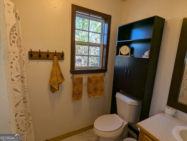 bathroom featuring vanity and toilet