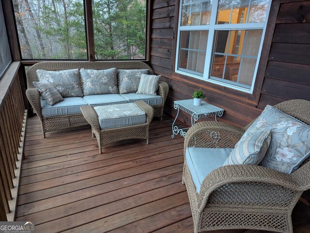 unfurnished sunroom featuring wood ceiling, ceiling fan, and vaulted ceiling