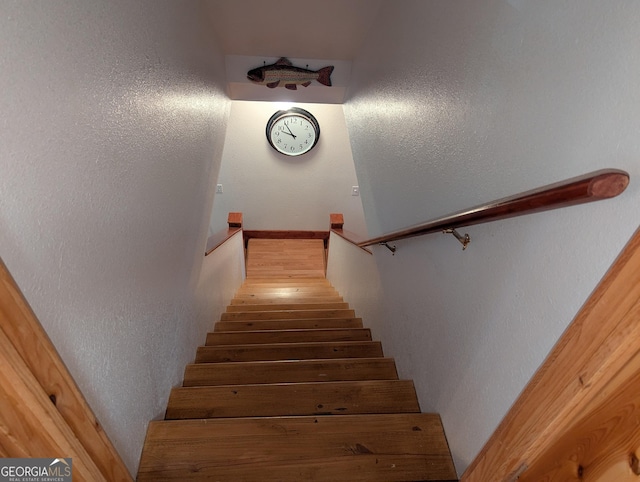 stairway featuring hardwood / wood-style flooring