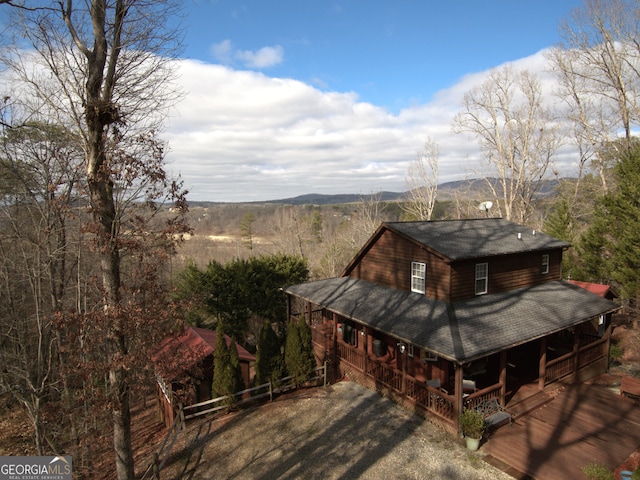 view of side of home featuring covered porch