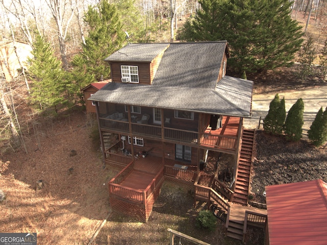 rear view of house featuring a wooden deck