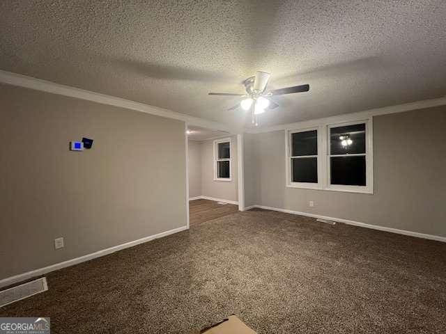 unfurnished room featuring ceiling fan, dark carpet, and a textured ceiling