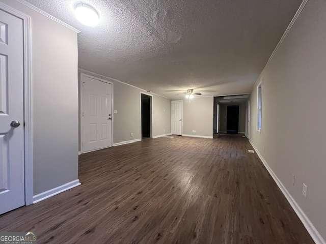 unfurnished living room featuring dark wood-type flooring and a textured ceiling