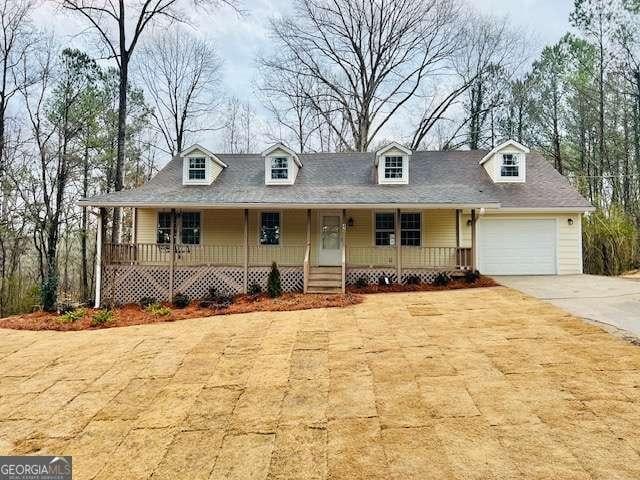 view of front of property featuring a garage and a porch