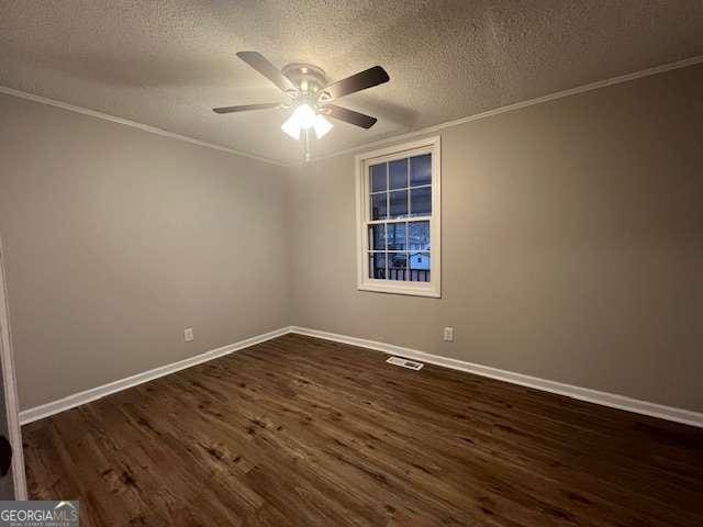 empty room with ceiling fan, ornamental molding, dark hardwood / wood-style floors, and a textured ceiling