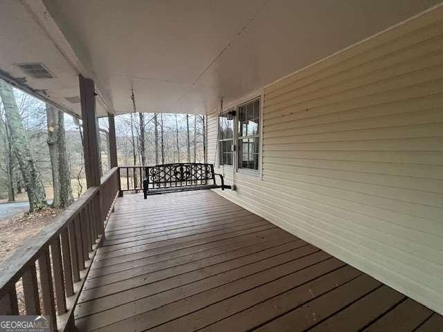 wooden terrace with a porch