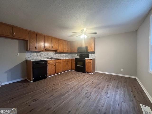 kitchen featuring tasteful backsplash, dark wood-type flooring, and black appliances