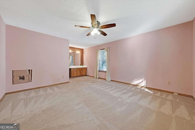 interior space featuring light colored carpet and ceiling fan