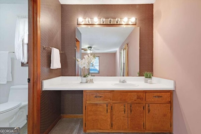 bathroom featuring vanity, ceiling fan, and toilet