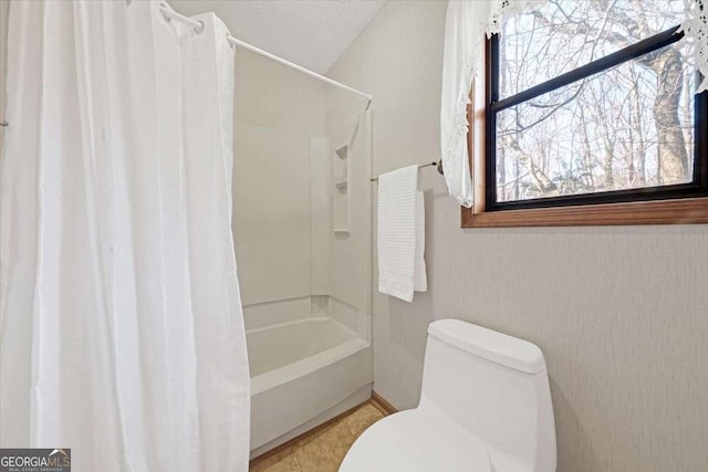 bathroom with shower / tub combo and toilet