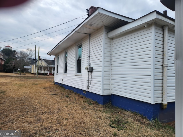 view of side of property with a yard