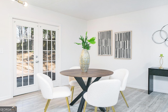 dining space featuring french doors, a healthy amount of sunlight, and light wood-type flooring