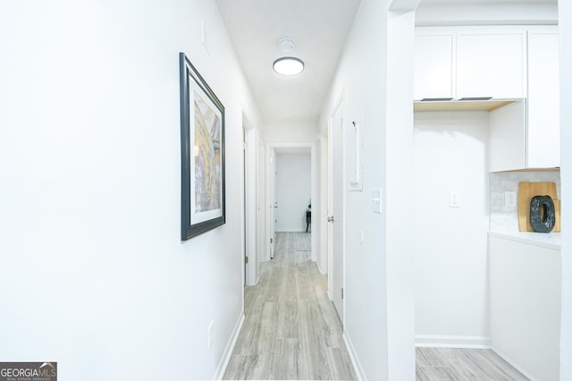 corridor with light wood-type flooring