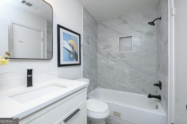 full bathroom featuring vanity, toilet, and tiled shower / bath