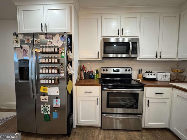 kitchen featuring dark hardwood / wood-style floors, wood counters, backsplash, white cabinets, and stainless steel appliances