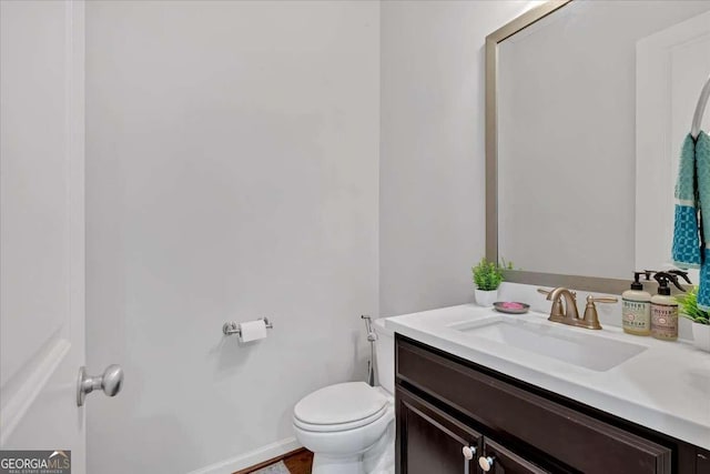 bathroom featuring vanity and toilet