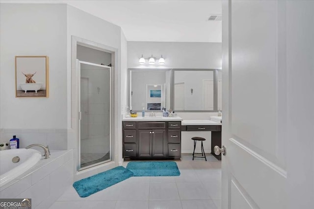 bathroom with tile patterned floors, separate shower and tub, and vanity