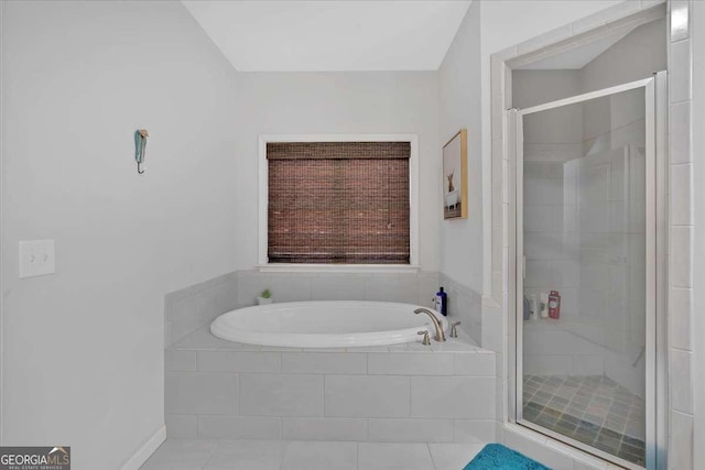 bathroom featuring tile patterned flooring and separate shower and tub