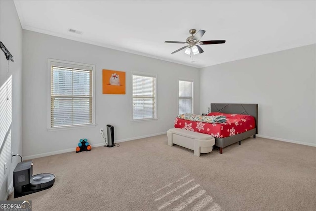 carpeted bedroom with crown molding and ceiling fan