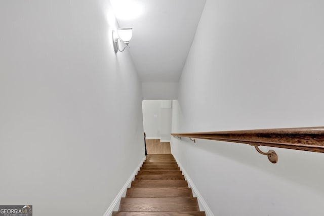 stairs featuring hardwood / wood-style floors