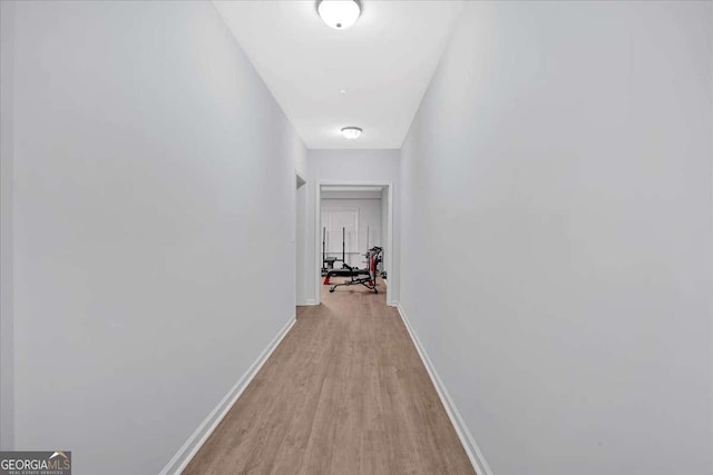 hallway with light hardwood / wood-style floors