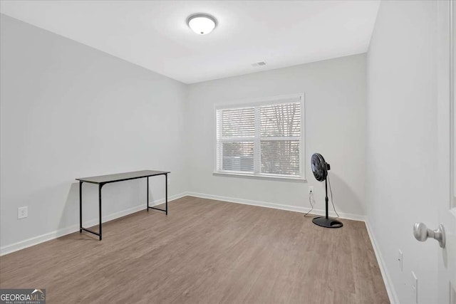 unfurnished room with light wood-type flooring