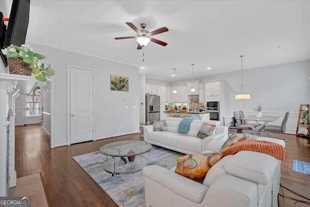 living room featuring crown molding, dark hardwood / wood-style floors, and ceiling fan