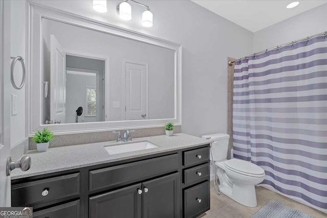 bathroom with vanity, tile patterned floors, and toilet