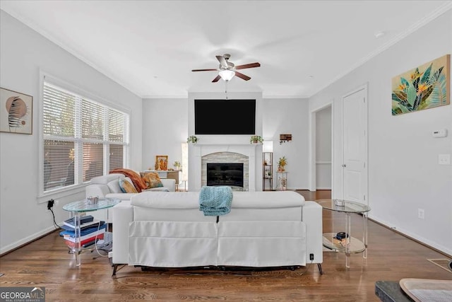 living room featuring ceiling fan, ornamental molding, and dark hardwood / wood-style floors