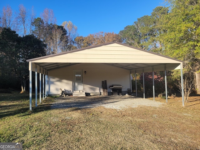 view of parking / parking lot featuring a carport and a yard