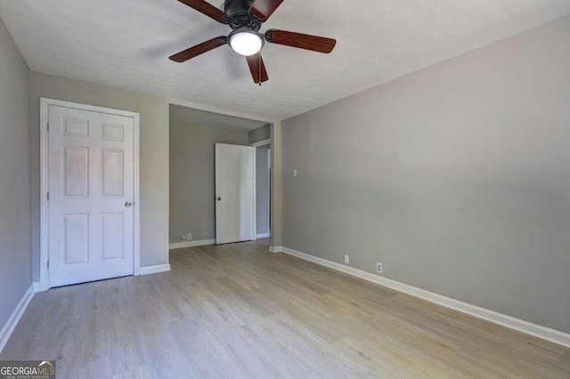 unfurnished bedroom with light hardwood / wood-style flooring and ceiling fan